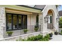 Charming porch with stone accents, black railings, and decorative plants creating an inviting entrance at 3379 Rennes Ne Dr, Brookhaven, GA 30319