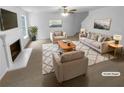 Bright living room boasts neutral tones, cozy seating, fireplace, and ample natural light at 4817 Enclave Dr, Union City, GA 30291