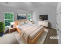 Staged main bedroom featuring large windows, a king-size bed, and modern furnishings at 4817 Enclave Dr, Union City, GA 30291