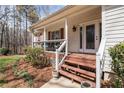 Cozy front porch with wood accents and detailed trim, providing a warm welcome and stylish outdoor space at 4150 E Chapel Hill Rd, Douglasville, GA 30135
