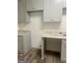 View of the kitchen featuring gray cabinets and gray counter tops at 103 Tiburon Ct, Stonecrest, GA 30038