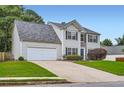 Charming two-story home featuring stone accents, manicured lawn, and an attached two-car garage at 1070 Evergreen Oak Way, Dacula, GA 30019