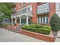 Classic brick building exterior with well-maintained landscaping and wrought iron balconies, exuding sophistication at 206 Ne 11Th Ne St # 703A, Atlanta, GA 30309