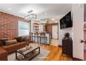 Inviting living room with exposed brick wall and updated lighting fixture at 36 Daniel Se St # 5, Atlanta, GA 30312