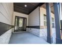 Inviting front porch with stone accents, dark trim, and a modern front door at 8088 Lakeview Pkwy, Villa Rica, GA 30180