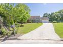 Well-maintained single-story home with a driveway leading to an attached garage and a mailbox at 1490 Twin Manor Dr, Loganville, GA 30052