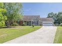 Inviting single-story home featuring a long concrete driveway and a well-maintained lawn at 1490 Twin Manor Dr, Loganville, GA 30052
