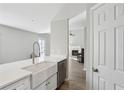 Bright kitchen featuring a farmhouse sink, stainless steel appliances, white cabinets and a view to the living room at 2058 Drogheda Ln, Marietta, GA 30066
