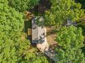 Aerial view of property with lush tree coverage, driveway and back deck at 5155 Oakdale Ct, Douglasville, GA 30135