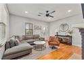 Cozy living room featuring hardwood floors, a comfortable sofa, and a modern ceiling fan at 571 Morgan Ne St, Atlanta, GA 30308