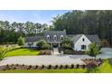 An impressive country home with a circular driveway, set among mature trees at 7255 Old Rico Rd, Chattahoochee Hills, GA 30268