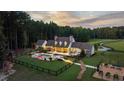 Aerial view of a luxury estate boasting a swimming pool, lush lawn, and a dark wood fence at 7255 Old Rico Rd, Chattahoochee Hills, GA 30268