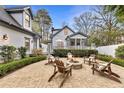 Inviting backyard patio with fire pit, string lights, and cozy seating, perfect for outdoor gatherings at 1466 University Dr, Atlanta, GA 30306