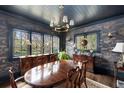 Elegant dining room with dark blue walls, traditional wooden table and chairs and chandelier lighting at 1466 University Dr, Atlanta, GA 30306