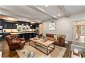 Beautiful living room and kitchen featuring a leather sofa and wood island with barstool seating at 1466 University Dr, Atlanta, GA 30306
