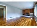 Open living room with gleaming hardwood floors and a cozy fireplace feature at 218 Woodview Se Ln, Smyrna, GA 30082
