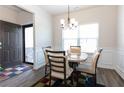 Cozy dining area featuring a stylish chandelier and large window with natural light at 103 Prominence Ct, Canton, GA 30114
