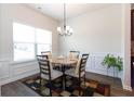 Bright dining area with a round table set and modern wainscoting at 103 Prominence Ct, Canton, GA 30114