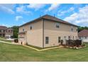 Spacious backyard with a wooden deck and vinyl siding on a two-story house at 1104 Stepping Stone Ln, Conyers, GA 30012