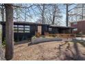 Modern home with dark exterior, stone accents, and natural wood porch and railing at 2382 Whites Mill Ln, Decatur, GA 30032
