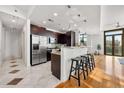 Modern kitchen with stainless steel appliances, dark wood cabinets, and a breakfast bar at 905 Ju Ne Street Ne St, Atlanta, GA 30309