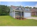 Charming home featuring a two-car garage and inviting landscaping at 109 Sunflower Ne Cir, Cartersville, GA 30121