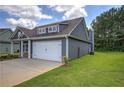 Side view of the house featuring a two-car garage and well-manicured lawn at 109 Sunflower Ne Cir, Cartersville, GA 30121