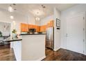 Modern kitchen featuring stainless steel appliances, wooden cabinets, and a stylish countertop with pendant lighting at 1418 Dresden Ne Dr # 385, Brookhaven, GA 30319