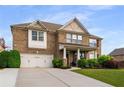 Attractive two-story brick home featuring a two-car garage and a well-maintained lawn at 1520 Gallant Fox Ln, Suwanee, GA 30024