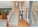Inviting foyer with a grand staircase, hardwood floors, and a bright, airy atmosphere at 2045 Calmwater Ct, Suwanee, GA 30024