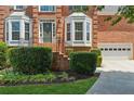 Charming front entrance featuring well-maintained landscaping and a convenient attached garage at 2045 Calmwater Ct, Suwanee, GA 30024