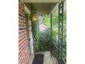 Cozy front porch with brick wall and climbing vines offers a tranquil entrance at 2226 Medfield Ne Trl, Atlanta, GA 30345