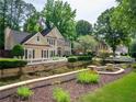 Beautiful home with manicured landscaping, lush lawn, and charming curb appeal at 9195 Tuckerbrook Ln, Alpharetta, GA 30022