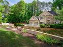 Beautiful home featuring manicured landscaping, lush lawn, and great curb appeal at 9195 Tuckerbrook Ln, Alpharetta, GA 30022