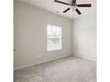 The bedroom offers neutral walls, cozy carpet, and a window that fills the space with natural light at 131 Prominence Ct, Canton, GA 30114