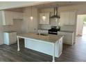 Modern kitchen featuring an island with granite countertops and stainless steel appliances at 204 Saratoga Dr, Acworth, GA 30102