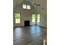 Bright living room with a fireplace, high ceilings, and light wood-look flooring at 204 Saratoga Dr, Acworth, GA 30102