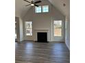 Open living room featuring a fireplace, vaulted ceiling, and lots of natural light at 204 Saratoga Dr, Acworth, GA 30102