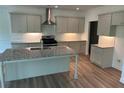 This spacious kitchen features granite countertops, stainless steel appliances, and gray cabinets at 208 Saratoga Dr, Acworth, GA 30102