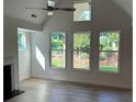 Sun-filled living room boasts vaulted ceilings, large windows, and neutral tones, creating a bright and airy atmosphere at 208 Saratoga Dr, Acworth, GA 30102