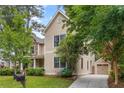 Exterior side view of a two-story home with a detached garage, lush landscaping, and a well-maintained lawn at 2217 Virginia Ne Pl, Atlanta, GA 30305