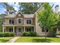 Elegant home with a stone facade, covered front porch, manicured landscaping, and a brick walkway at 2217 Virginia Ne Pl, Atlanta, GA 30305