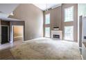 Bright living room with high ceilings, a fireplace, and large windows providing natural light at 1130 Timbercreek Ct, Alpharetta, GA 30005