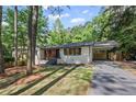 Charming renovated home featuring a light brick facade and convenient carport in a lush, wooded setting at 2238 Pinecliff Ne Dr, Atlanta, GA 30345