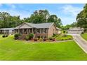 Well-maintained home featuring a lush lawn and a detached multi-car garage at 4010 Hamilton Mill Rd, Buford, GA 30519