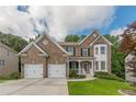 Beautiful two-story brick home with a two-car garage and landscaped front yard at 5342 Lakerock Sw Dr, Atlanta, GA 30331