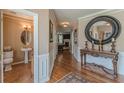 Inviting foyer with hardwood floors, elegant console table, and a decorative mirror at 5342 Lakerock Sw Dr, Atlanta, GA 30331