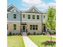Inviting townhome exterior with brick facade and landscaped front yard at 1240 Ainsworth Aly # 39, Sugar Hill, GA 30518