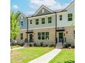 Beautiful townhome exterior with manicured lawn and charming entrance at 1240 Ainsworth Aly # 39, Sugar Hill, GA 30518