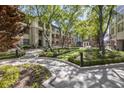 Beautifully landscaped courtyard with winding pathways, mature trees, and vibrant flowerbeds at 3475 Oak Valley Rd # 1850, Atlanta, GA 30326